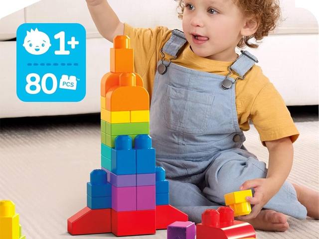 A toddler stacking big MEGA Bloks